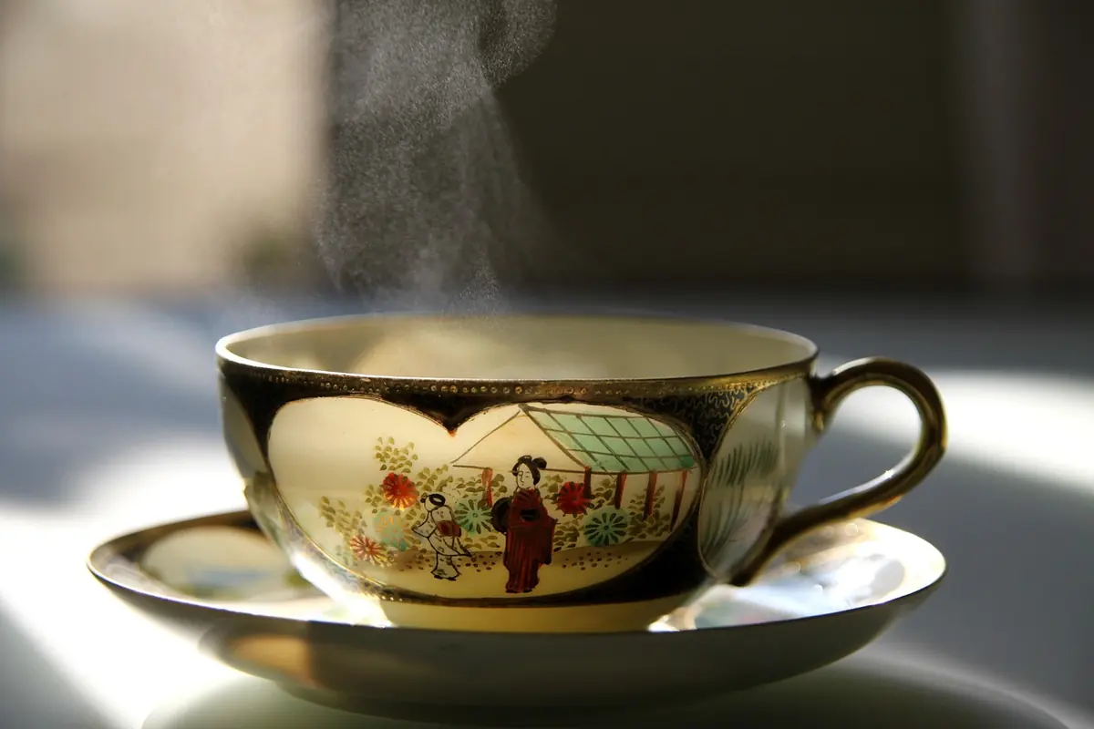 A steaming cup of tea on a saucer