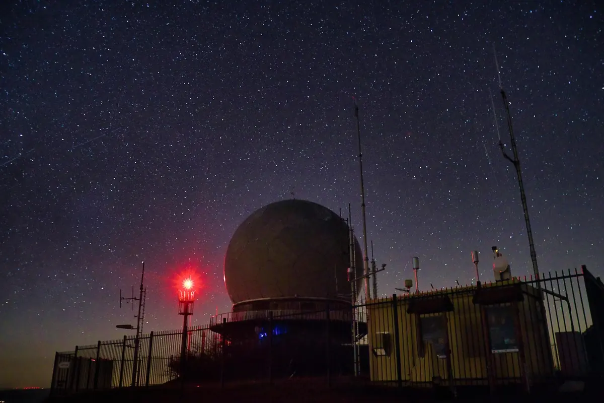 An observatory under a starry night sky