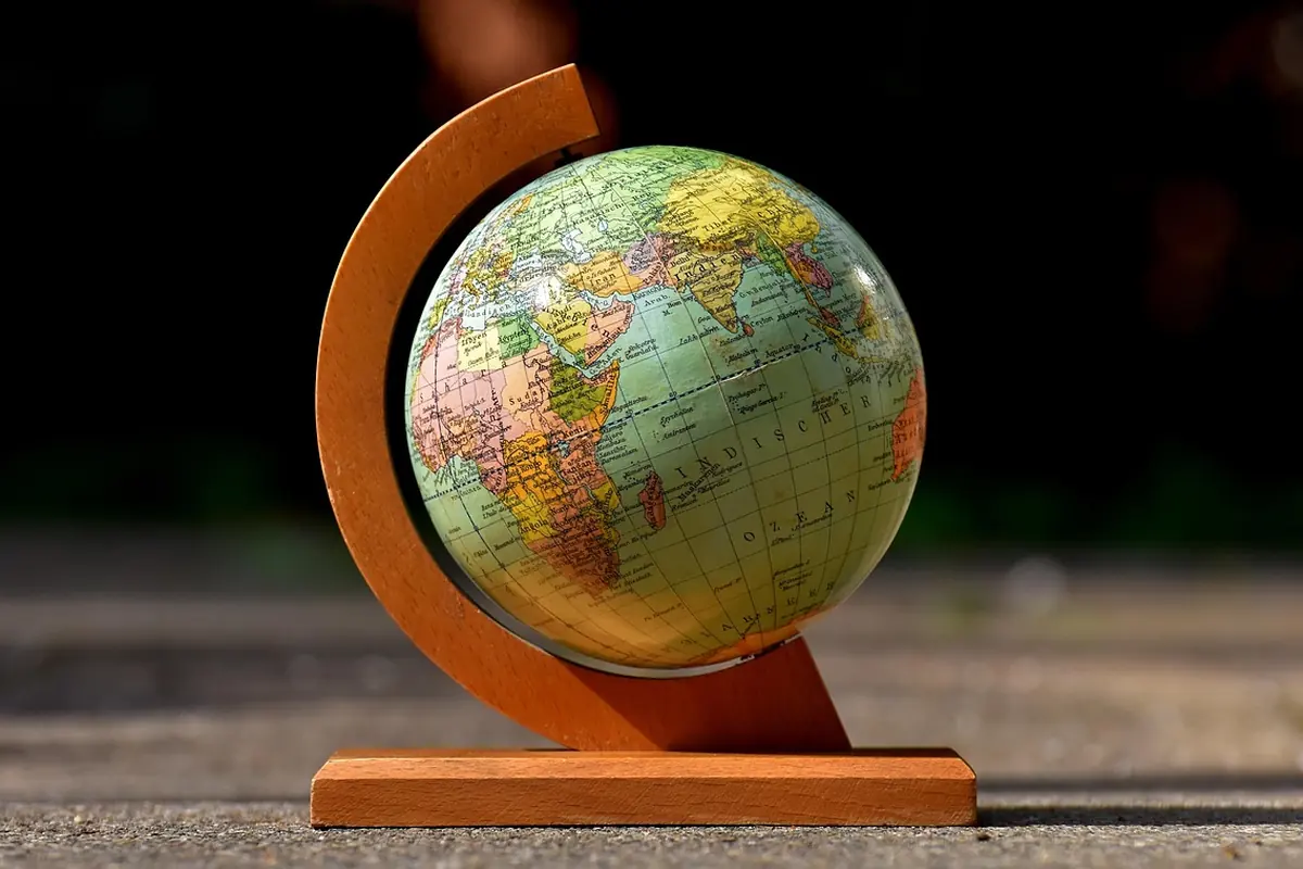A desk globe on a wooden stand