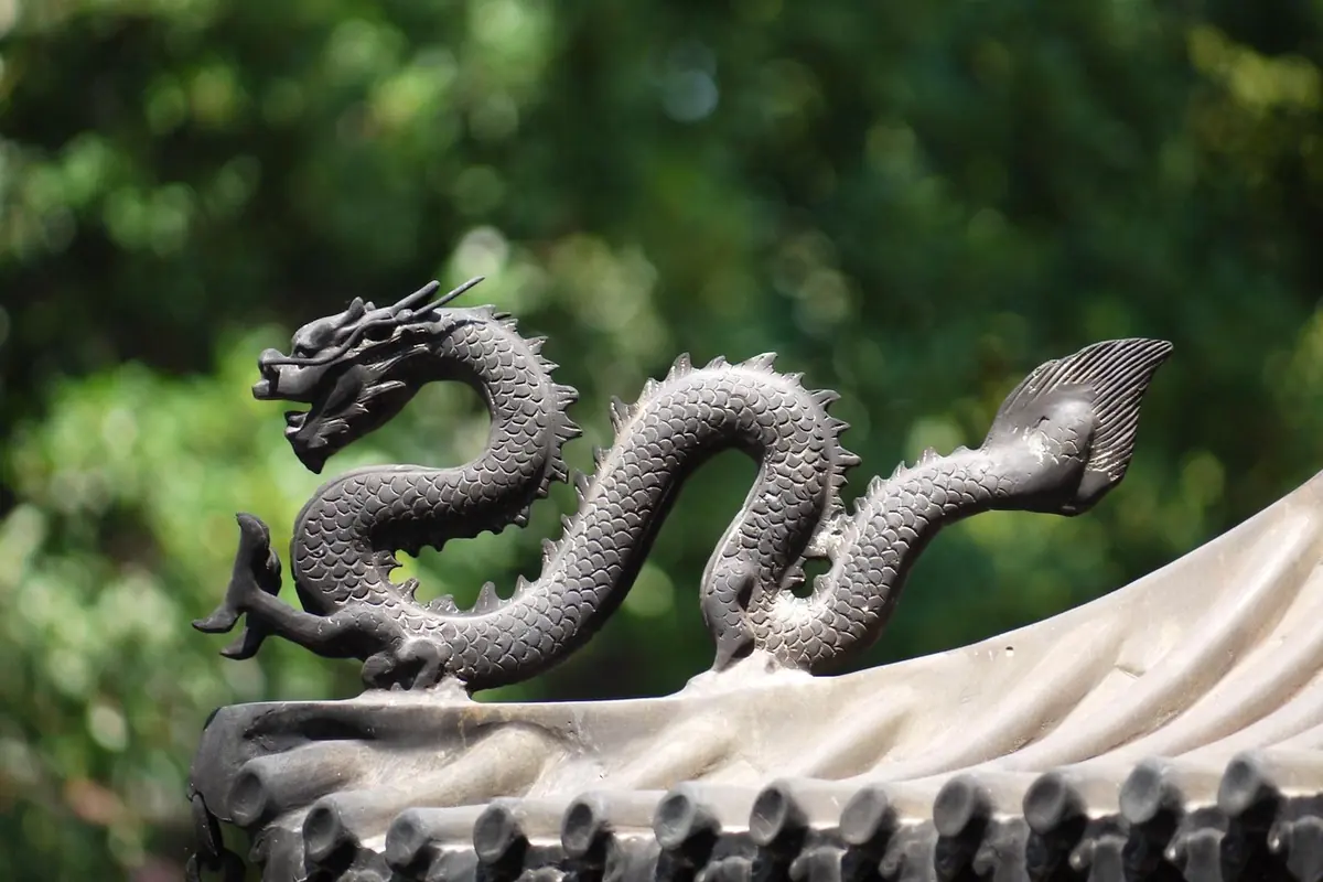 A carved dragon sculpture on a temple roof